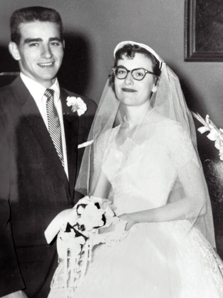 A past photo of Dottie on her wedding day, standing next to her husband Arnold.